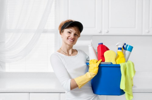 Technician checking cleaning supplies and safety procedures